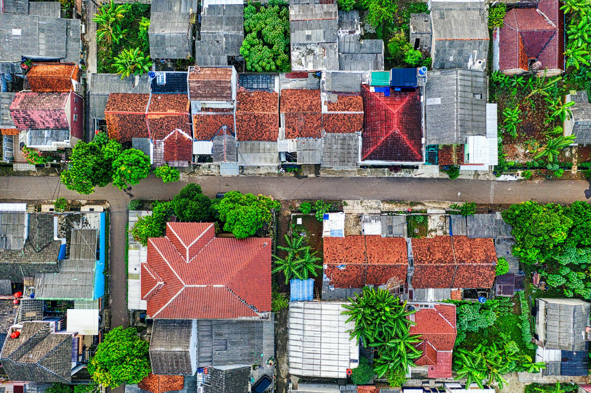 A colorful aerial shot of residential houses with lush greenery in Banten, Indonesia.