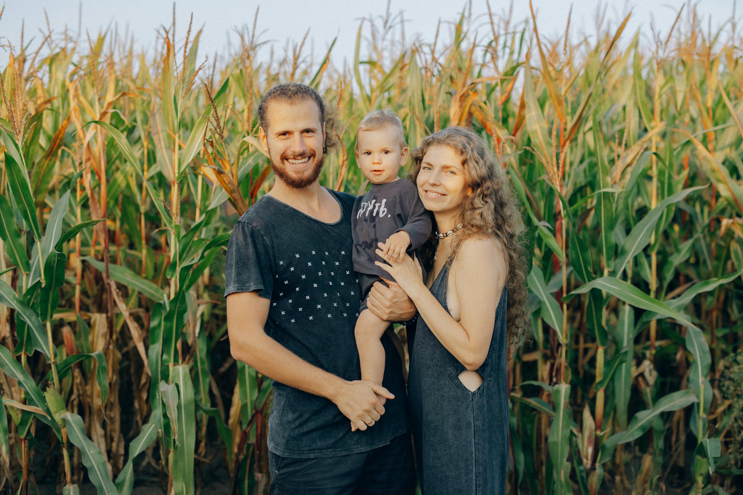 Enjoying family time in a corn field during summer sunset.